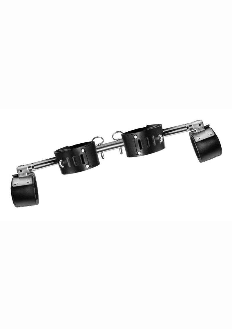 aided by 4 adjustable leather cuffs . The fixed cuffs in the middle are secured at the back with a metal plate for extra sturdiness. Each cuff at the end of the bar is attached to a pivoting joint