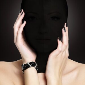 This comfortable Subjugation mask is designed to stretch completely over the head and closes easily at the back with a zipper. The fabric allows just a hint of light in while impairing vision and awakening  other senses. The shiny hood can be worn by him or her